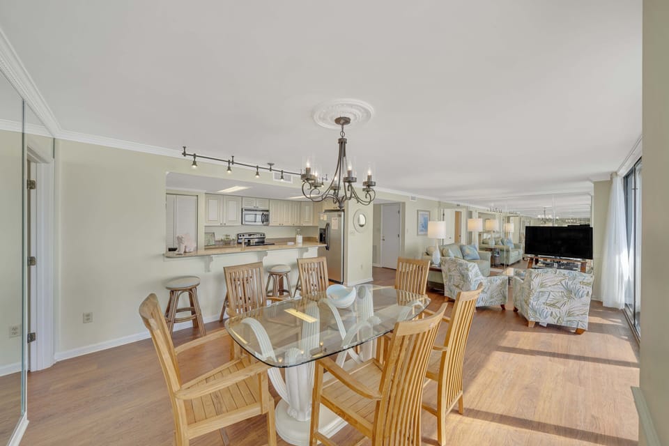 There is a dining table, perfect for enjoying a meal or playing a game, as well as additional breakfast bar seating.