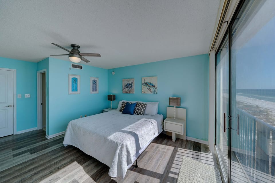 The second bedroom also has a King-sized bed, a television, & more floor-to-ceiling gulf views.
