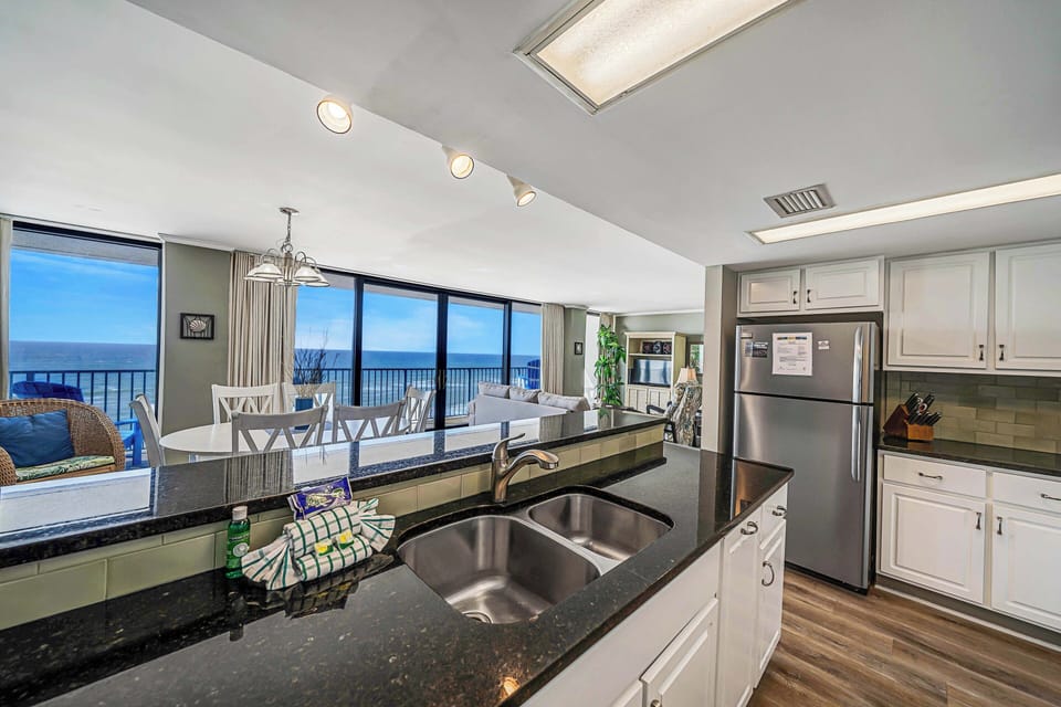 The fully equipped kitchen has everything you need to prepare meals for family & friends. It features granite countertops, stainless-steel appliances, and beautiful subway tile backsplash.