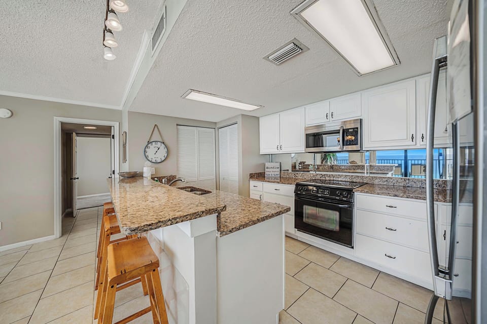 The fully equipped kitchen features granite countertops and has everything you need to prepare meals for family and friends.