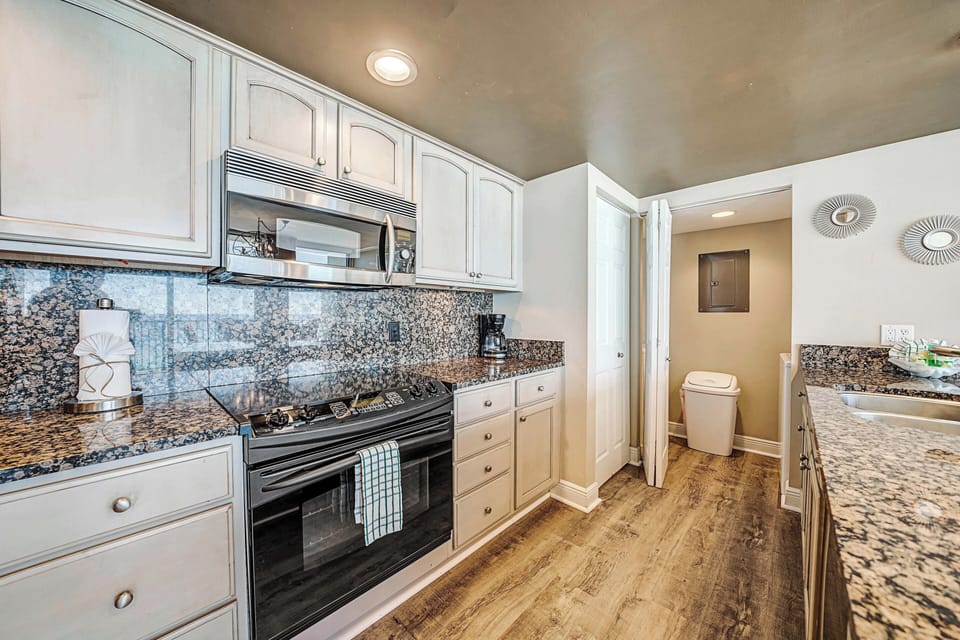 The fully equipped kitchen features granite countertops, stainless-steel appliances, and everything you need to prepare meals for family & friends.