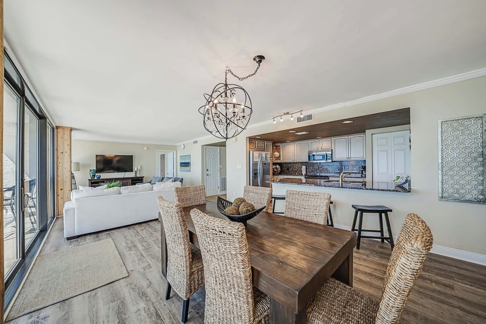 There is a dining table, perfect for enjoying a meal or playing a game, as well as additional breakfast bar seating.