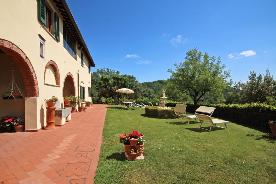 The exterior of the farmhouse and the shared garden