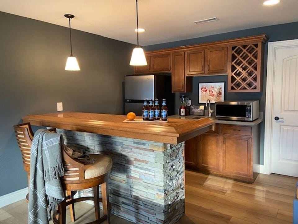 Lower level bar with additional refrigerator and microwave