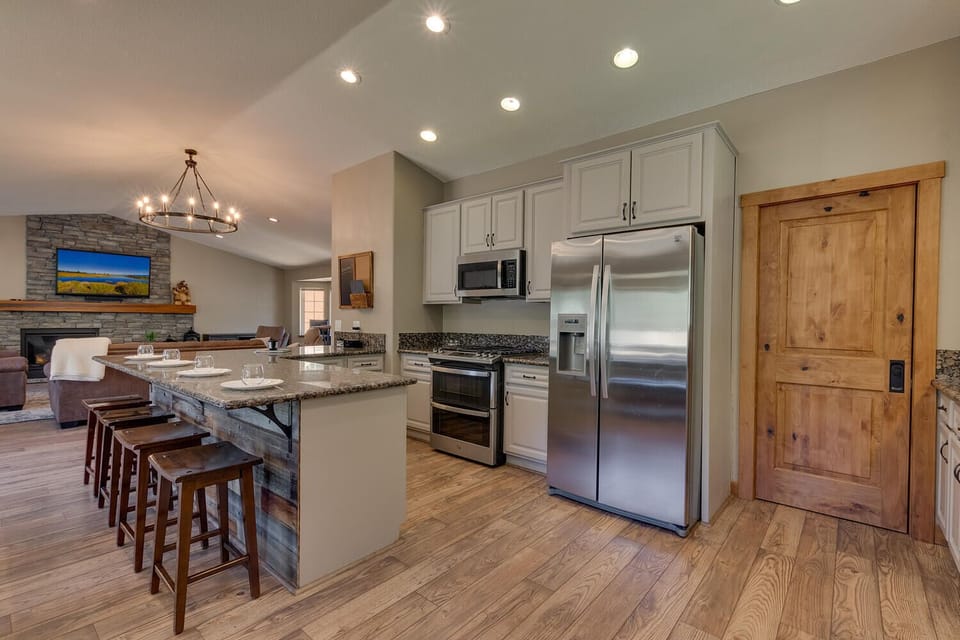 - Modern kitchen with stainless steel appliances  
- Granite island with seating for casual dining  
- Open-concept layout flows into living and dining