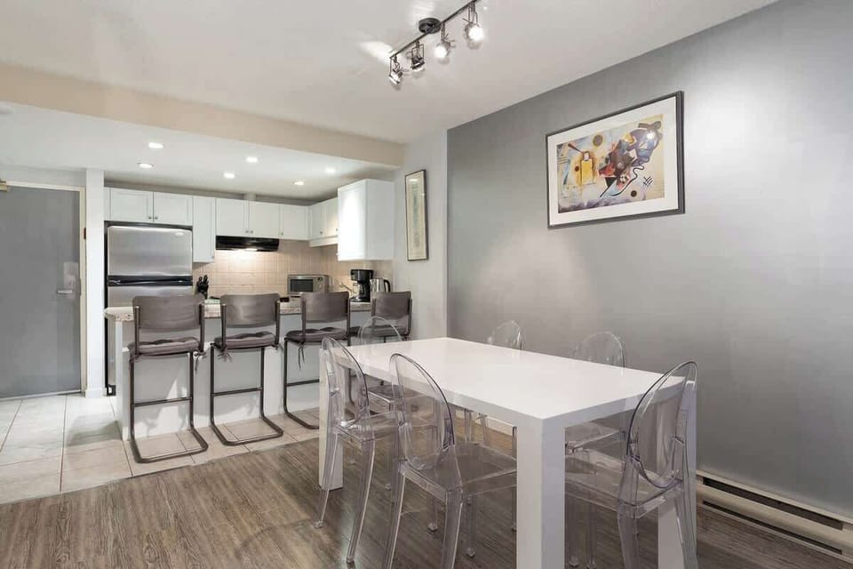 - Bright Whistler dining area with modern table and chairs  
- Open-concept layout connecting to sleek kitchen space  
- Perfect for group meals and cozy Whistler gatherings  
