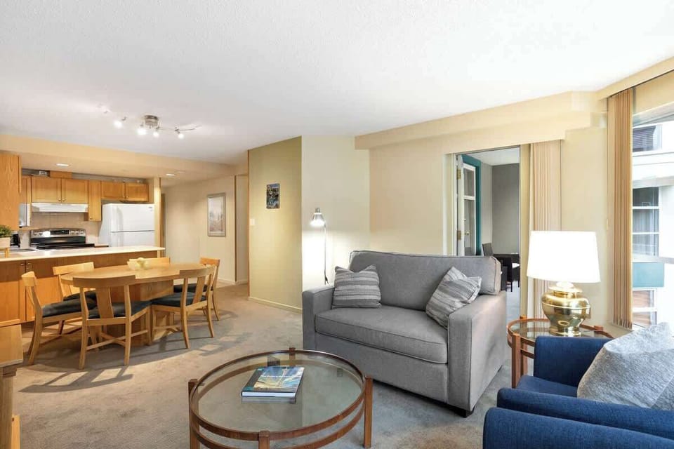 - Spacious living room with modern furniture and cozy fireplace ambiance  
- Mountain resort condo blending comfort with style for relaxation  
- Ideal Whistler accommodation near lifts and village attractions  