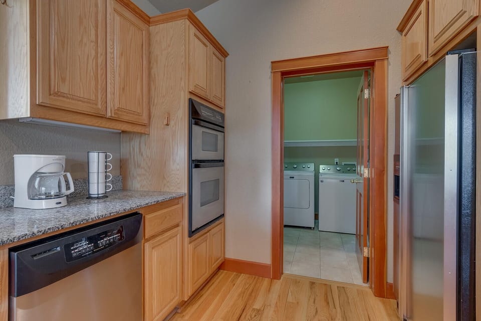 - Kitchen with double ovens and modern appliances  
- Coffee maker and essentials for your morning brew  
- Laundry room with washer and dryer conveniently