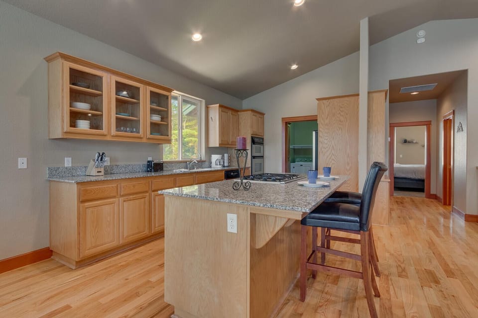 - Spacious kitchen with open shelving and storage  
- Large island with seating for casual dining  
- Easy access to living room and bedrooms nearby