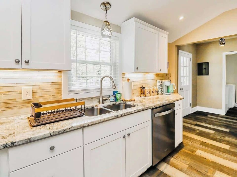 Fully stocked kitchen with new appliances and cooking supplies. 