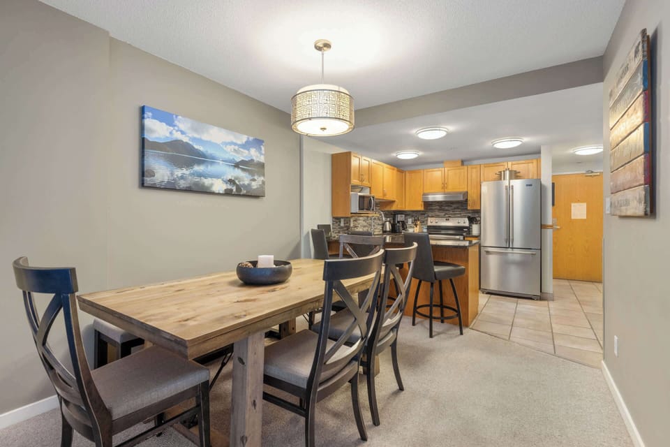 - Dining area with rustic wooden table for family meals  
- Open design flows into the kitchen and living room  
- Perfect for shared meals after mountain adventures  