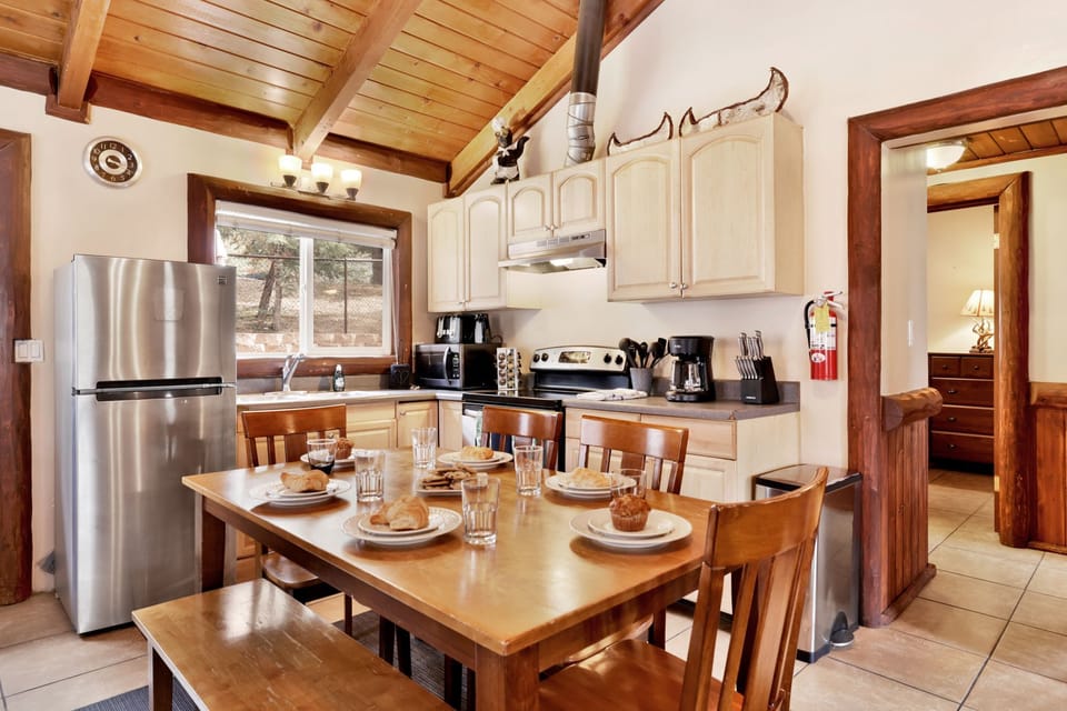 Fully equipped cabin kitchen with ample cabinetry, stove, fridge, microwave, and coffee maker—perfect for cooking meals, morning coffee, and feeling right at home on your stay.