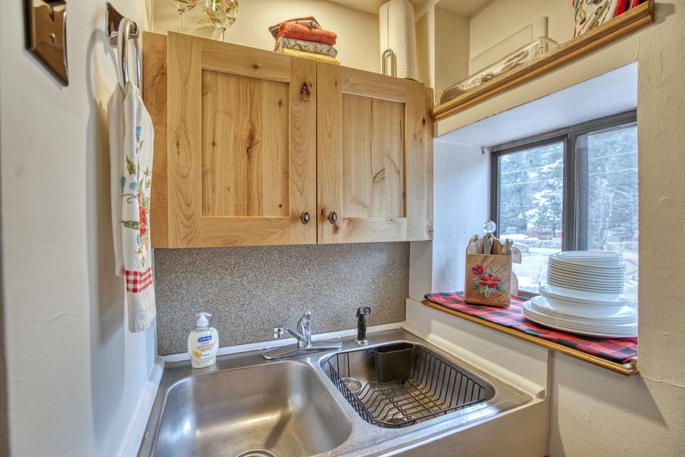 Fully stocked kitchenette includes microwave, coffee maker, toaster, and hot plate. Also cookware, dishes, utensils and basic spices.