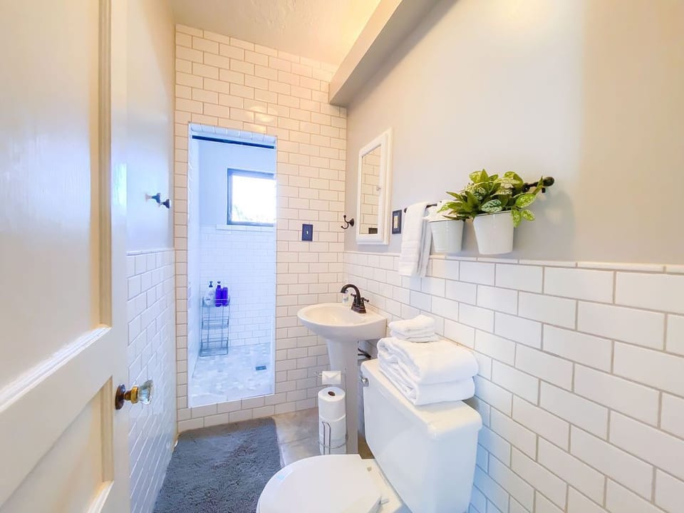 The modern feel of this tiled lavatory is complimented by the lighting.