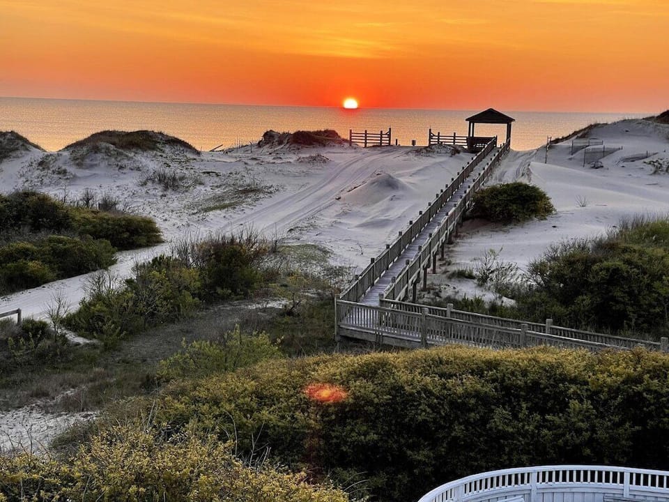 Experience stunning sunrise ocean views from the house, or stroll the boardwalk for an immersive sand-between-your-toes OBX beach moment. The ideal setting for your destination wedding or event.