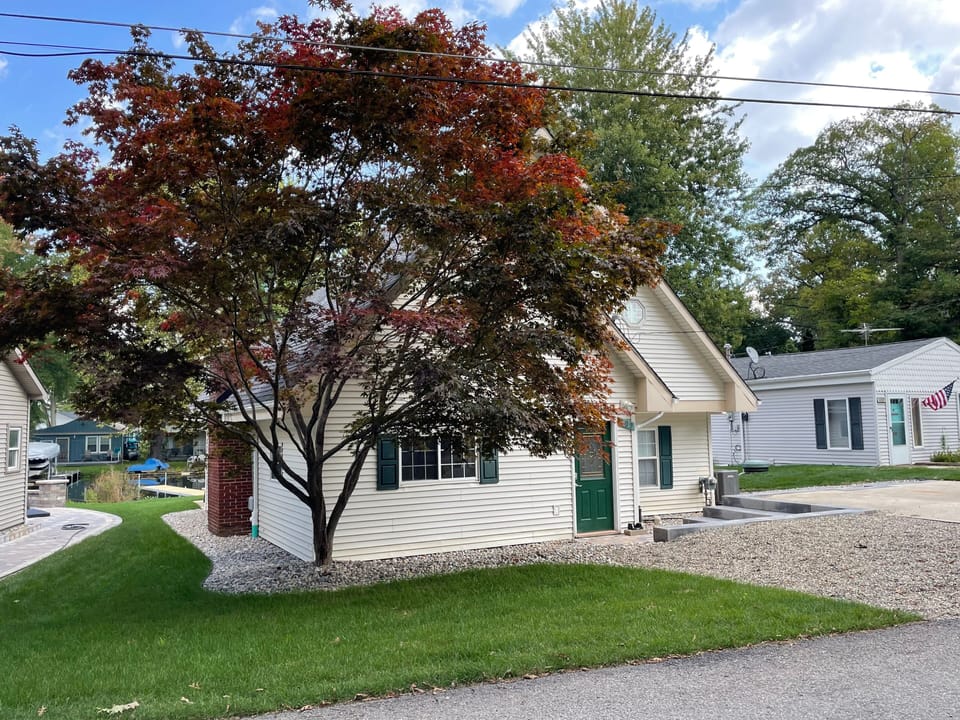 Street-side view of house, lawn, parking area