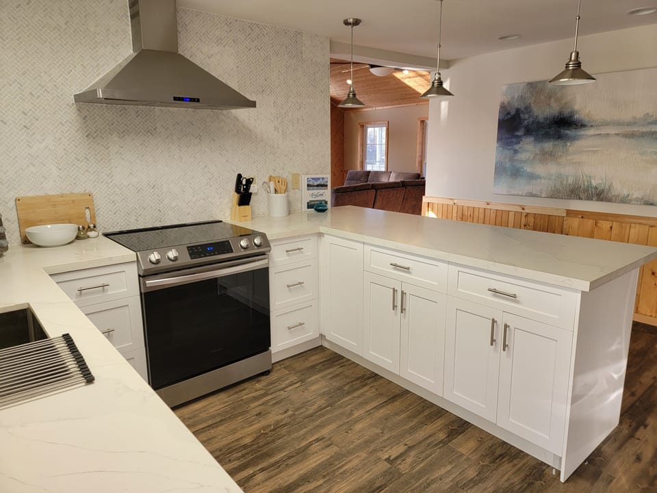 Prepare meals in this new, stocked kitchen with stainless steel appliances.