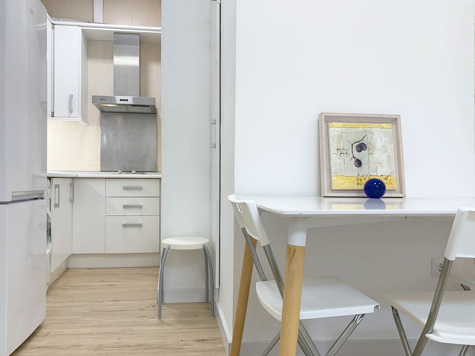 Cozy kitchen with stove, refrigerator and storage