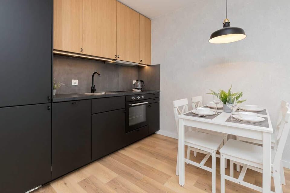 The sleek design of the kitchenette blending seamlessly with the living area.