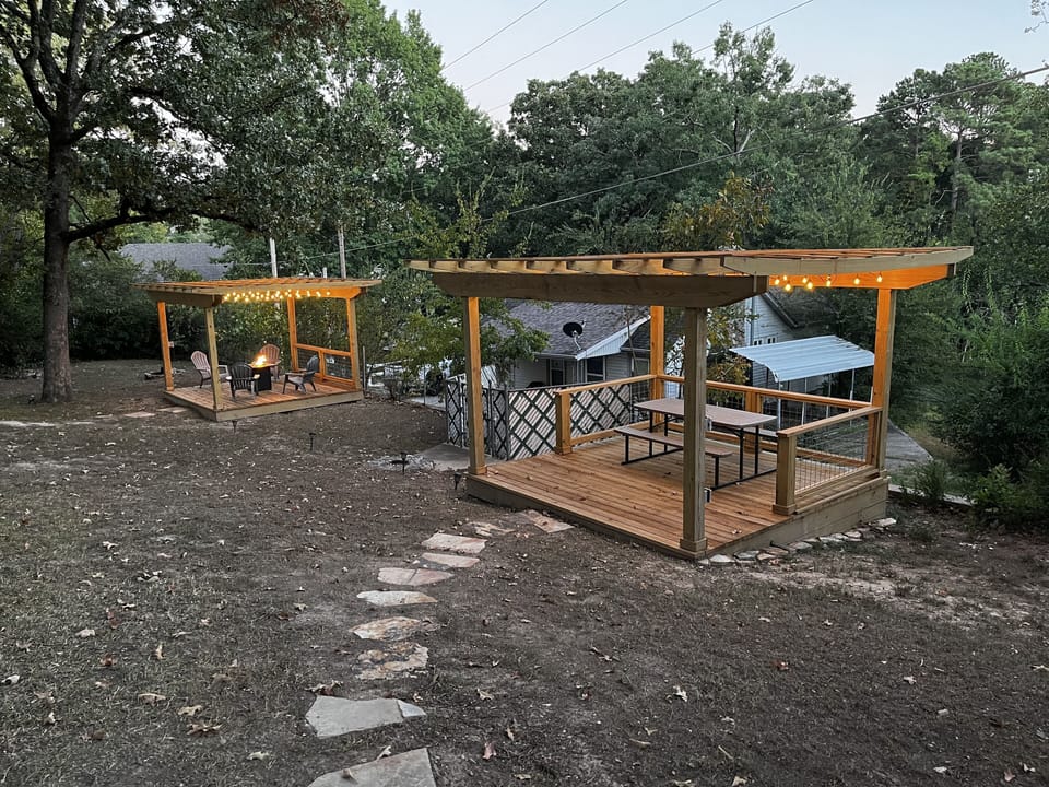Two pergolas. One with fire pit and the other for dining, games or conversation.