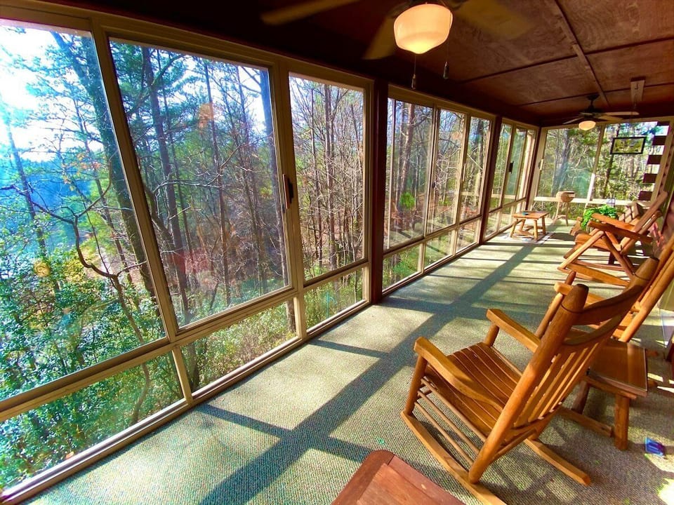 This expansive sunroom is accessible from the side deck and from the living room. Take in the sunrise while sipping
coffee on the rockers or swing. Slide open the windows and/or the screens to breathe in the fresh air and unite with
nature!