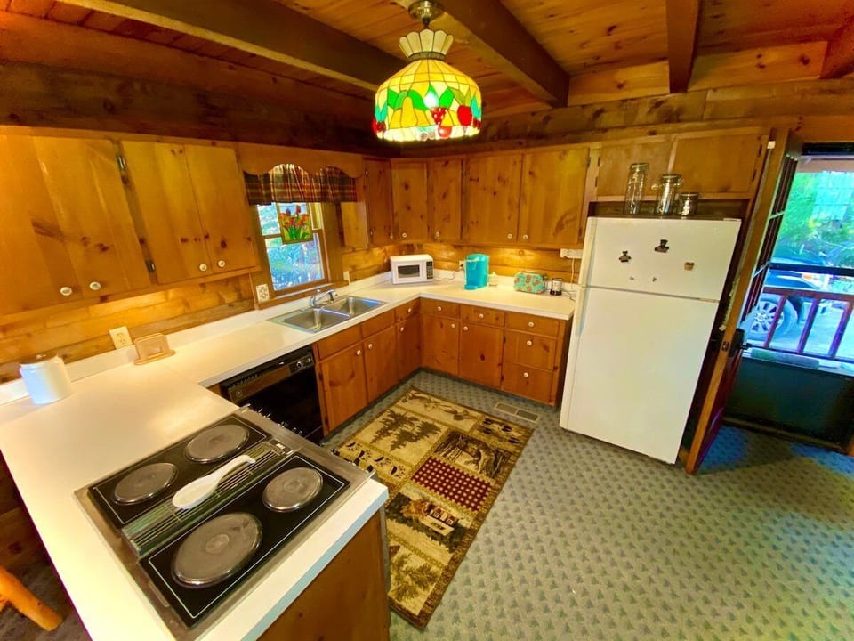 The kitchen has plenty of room for anyone who wants to cook or graze. Enjoy a cup of delicious coffee with a new
Keurig coffeemaker. Fully stocked with dishes, pots, pans, microwave, and toaster. Check out the cast-iron stove
burners!