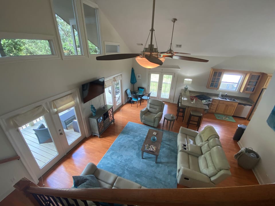 Living room with flat screen and recliner and sofas that all recline 