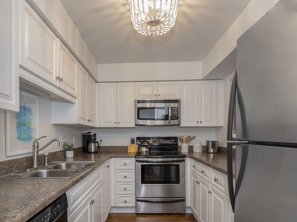 White cabinetry and stainless steel appliances in the kitchen