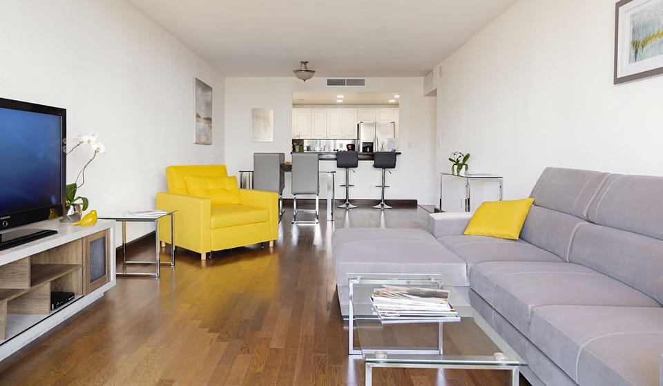 Spacious living room with a dining table and convertible sofas.