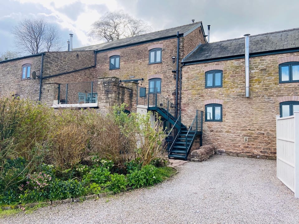 The private driveway to hold two cars and the stairs leading to the cottage.