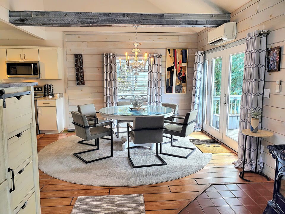 The dining table seats 6 - 8, and French doors lead to the back deck.