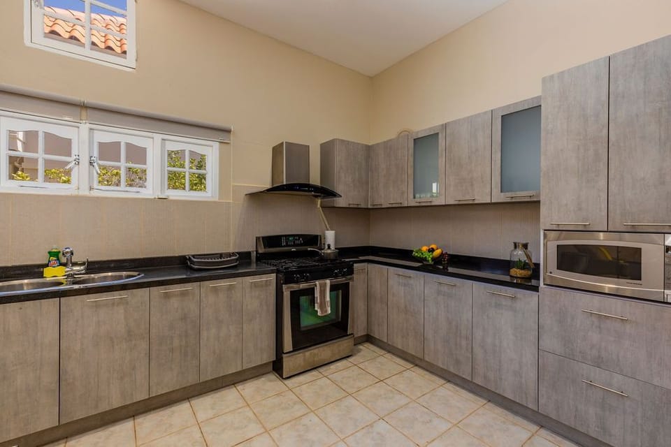 The full kitchen has a fridge, a stove, oven, vent, and microwave.