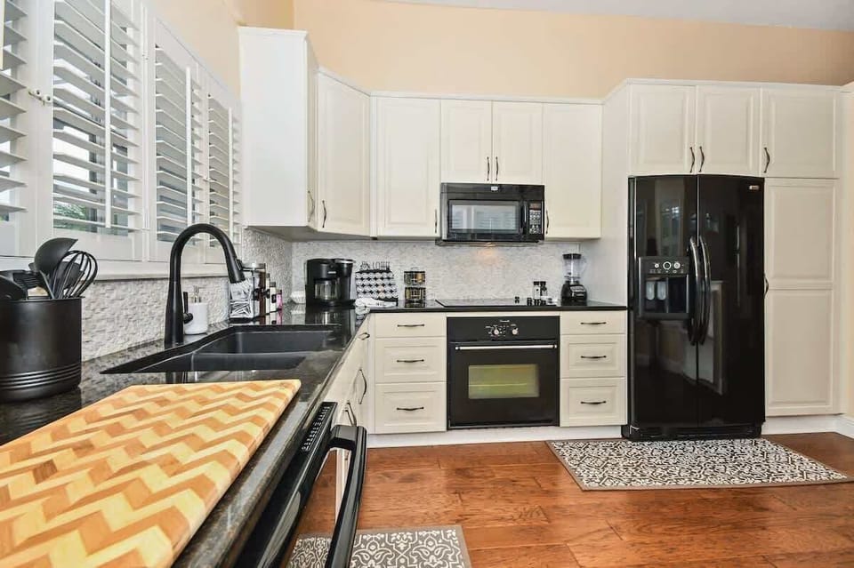 Beautiful, elegant & spacious kitchen stocked with everything you should need (probably a few things you don't)! Pots & pans, silverware, plates, bowls, cups, glasses, coffee mugs, wine glasses, blender, Keurig Duo, spice rack, knives, etc.