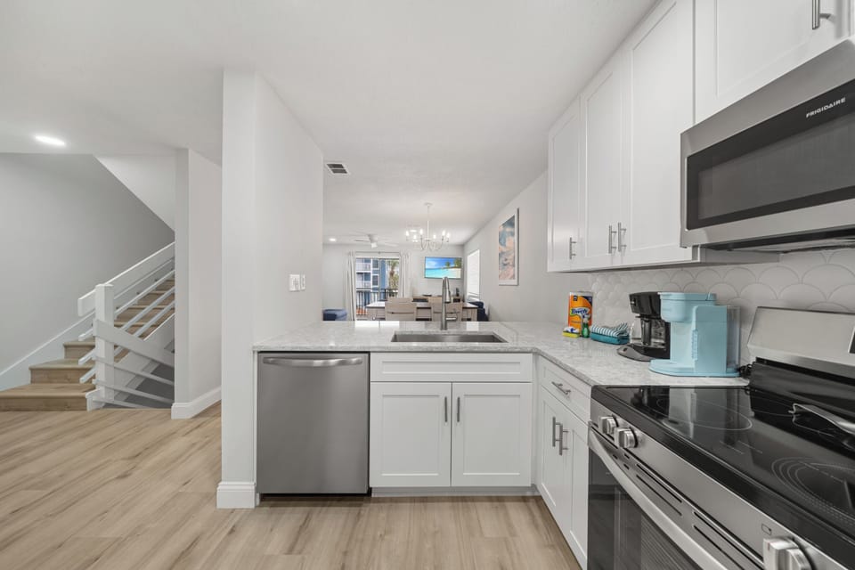Second Floor: Kitchen, dining, living room, laundry room, pantry, half bath.