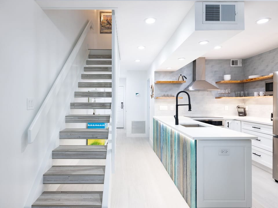 Prep dinner at the oversized island under soft recessed lighting.