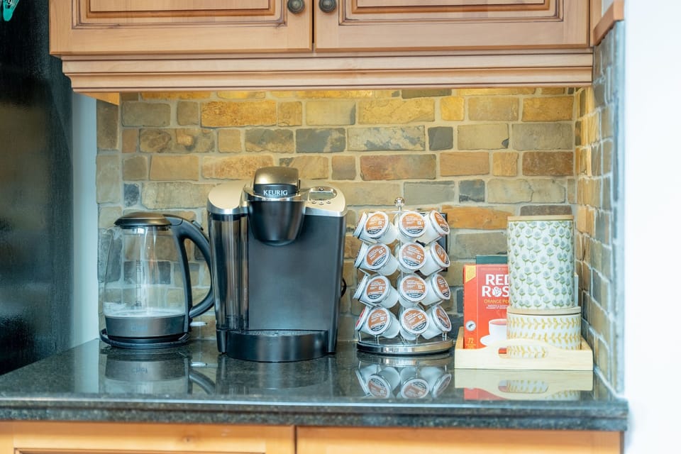 Coffee maker, kettle, and storage on a countertop
