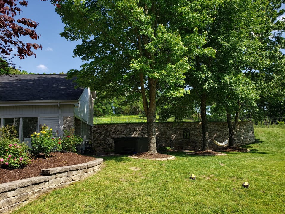 View of the side of guest house with walk out to hot tub