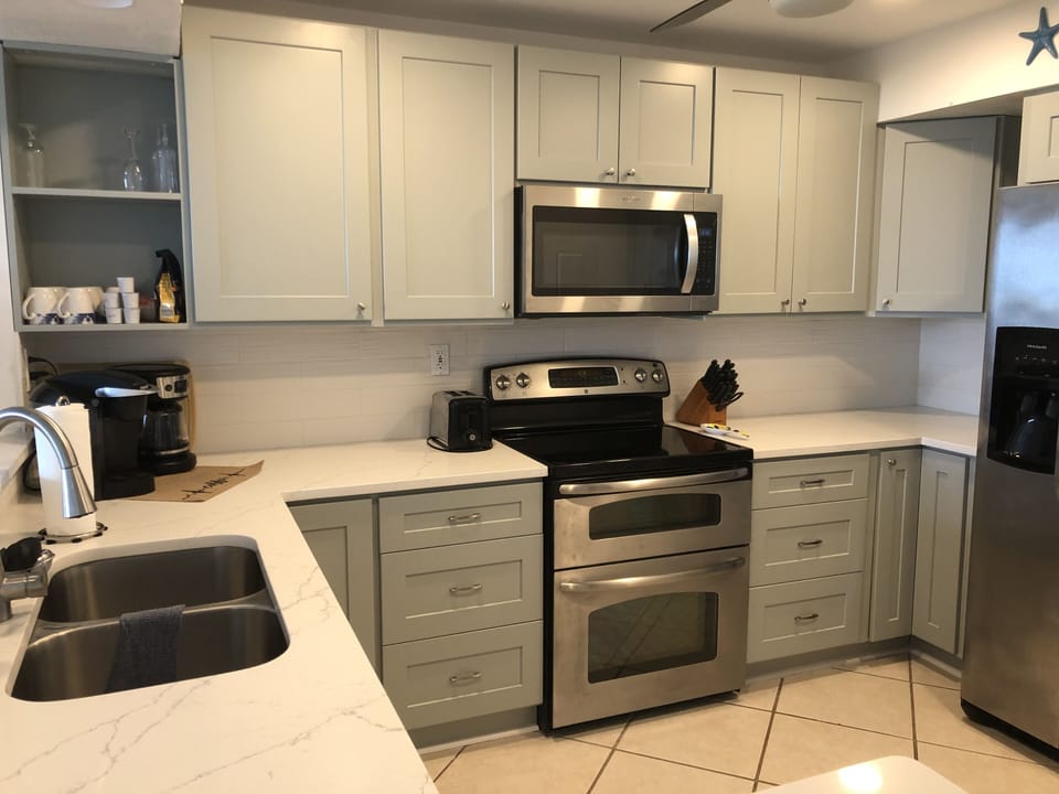 Electric stove, double oven, microwave and large refrigerator and coffee pot 