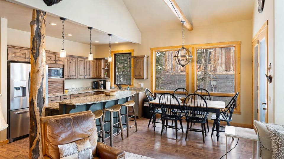 Open concept living room, dining area, fully stocked kitchen, and outdoor dining space.