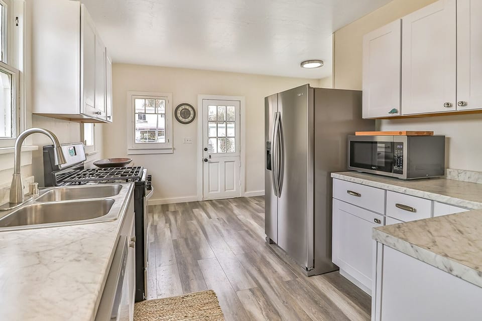 Kitchen equipped with full size frig, dish washer, microwave and stove. 