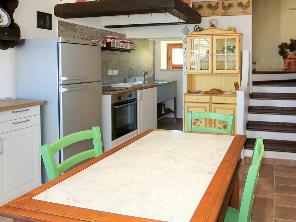 Cabinetry, Furniture, Property, Table, Countertop, Wood, Kitchen Appliance, Chair, Kitchen Stove, Flooring