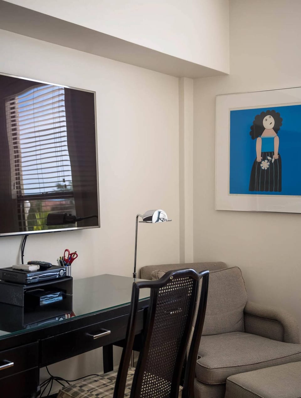 Workspace area with a smart flatscreen tv. Lounge chair in the bedroom