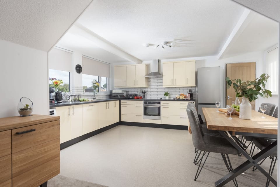 Spacious kitchen with coffee machine, oven and dining area- Bridge Apartment