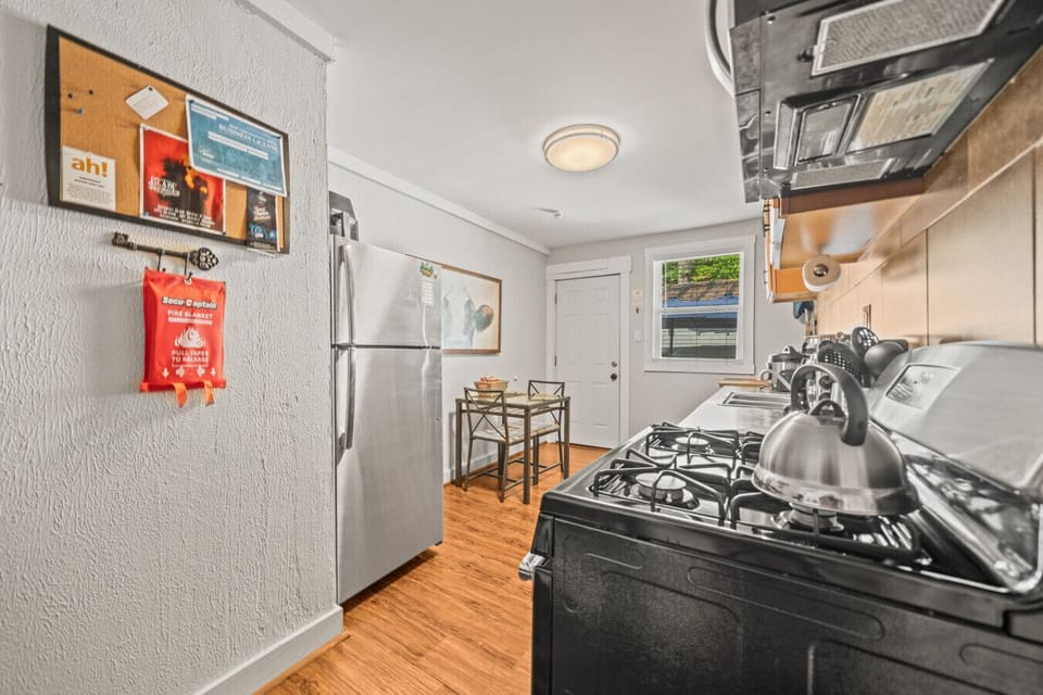 Full kitchen with eat-in area and backdoor leading to laundry and patio.