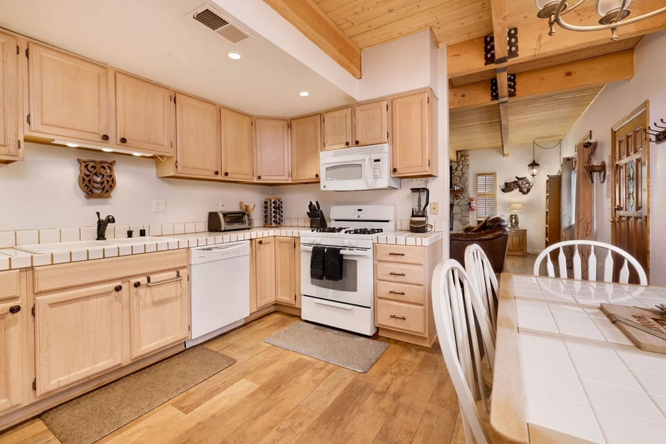 Fully equipped cabin kitchen with ample cabinetry, stove, fridge, microwave, and coffee maker—perfect for cooking meals, morning coffee, and feeling right at home on your stay.