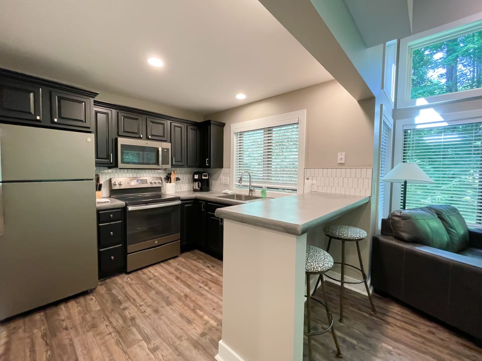 Enjoy the view while you cook - Whether staring out the window at the beautiful nature scape or working in the fully remodeled kitchen, you'll enjoy your time here.  Poured concrete countertops, deep sink, new appliances and cabinets.