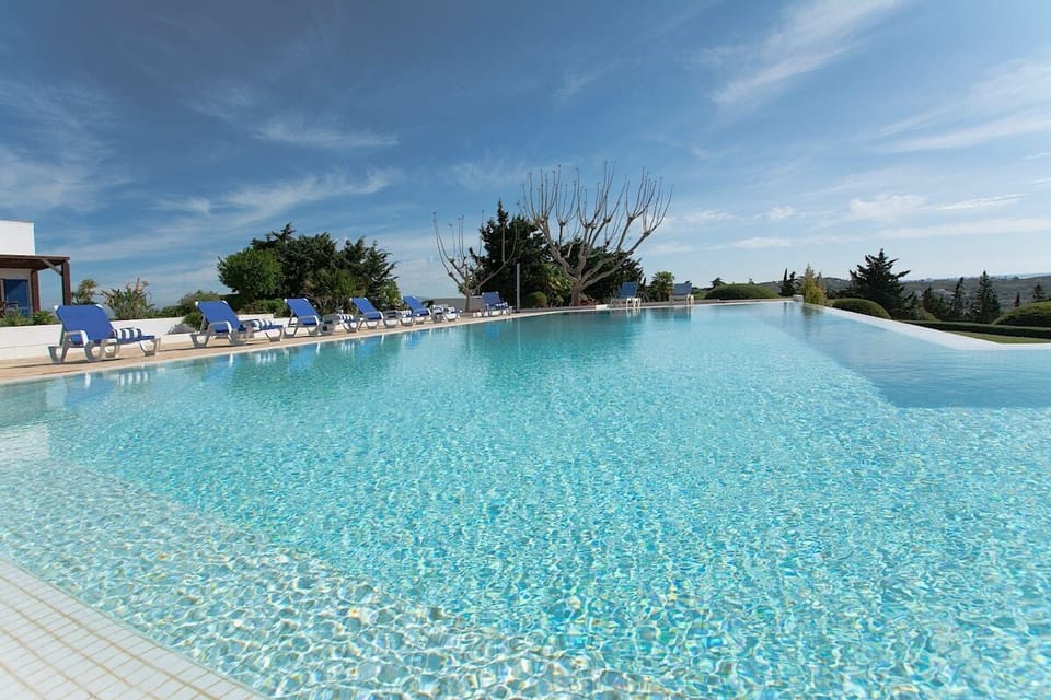 Sparkling outdoor swimming pool with blue loungers — Villa Alfarrobeira, holiday villa in Lagos