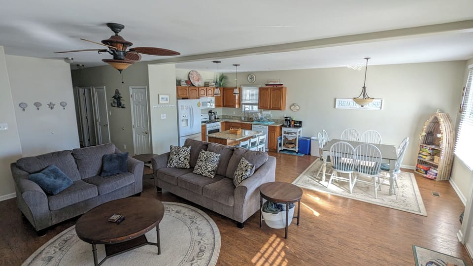 Living room, dining area and kitchen conveniently situated in open space layout.