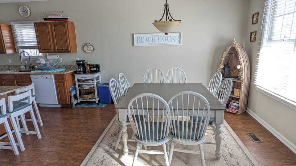 Dining table seats 8, with additional seating on kitchen island.