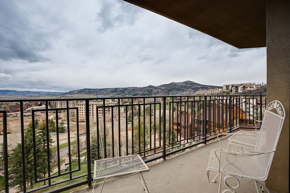 Expansive balcony with mountain and city views, featuring comfortable seating for relaxing mornings and peaceful evenings.